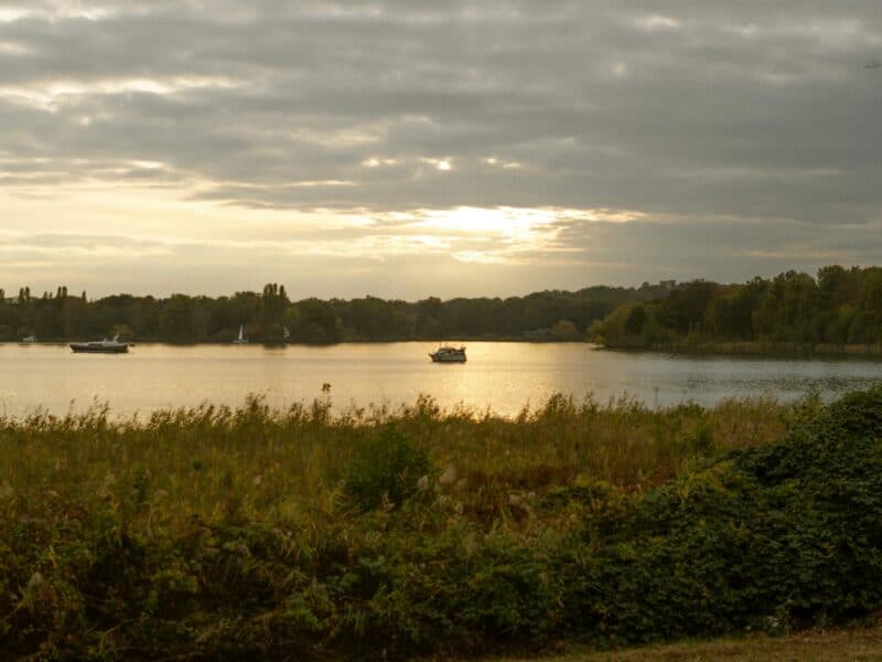 serene river scene at sunset with boats