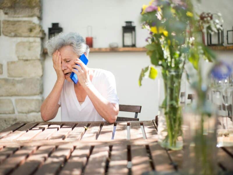 elderly woman crying while on phone call