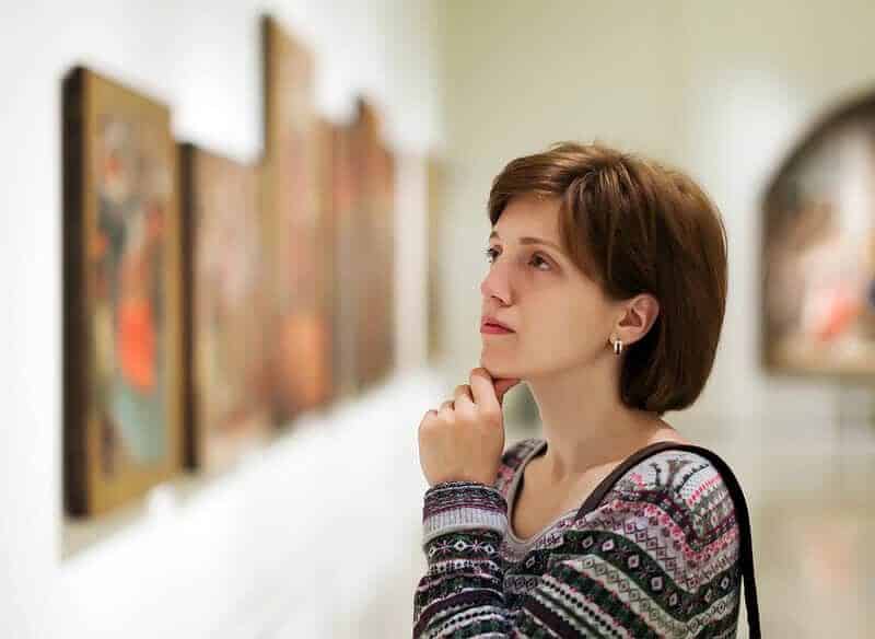 visitor looking pictures art gallery
